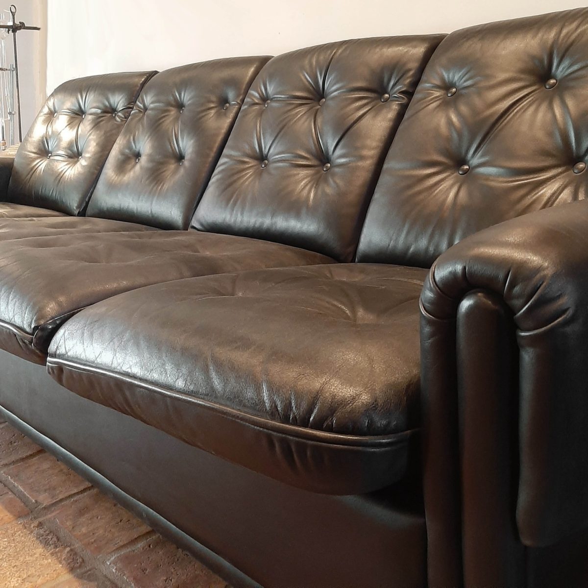 Vintage fourseater sofa made of black leather Piet Jonker