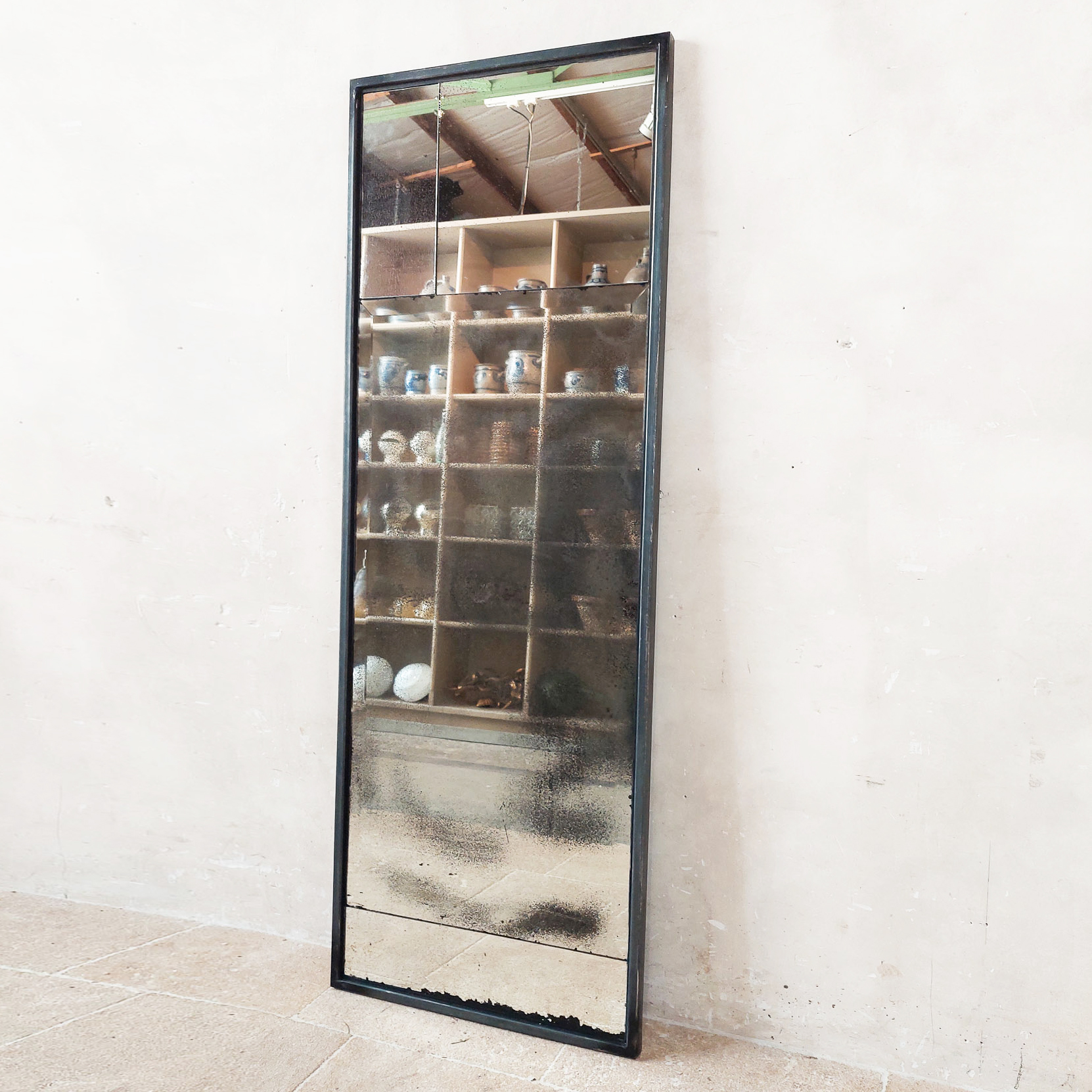 High narrow "patchwork" mirror of antique mirror glass with black iron